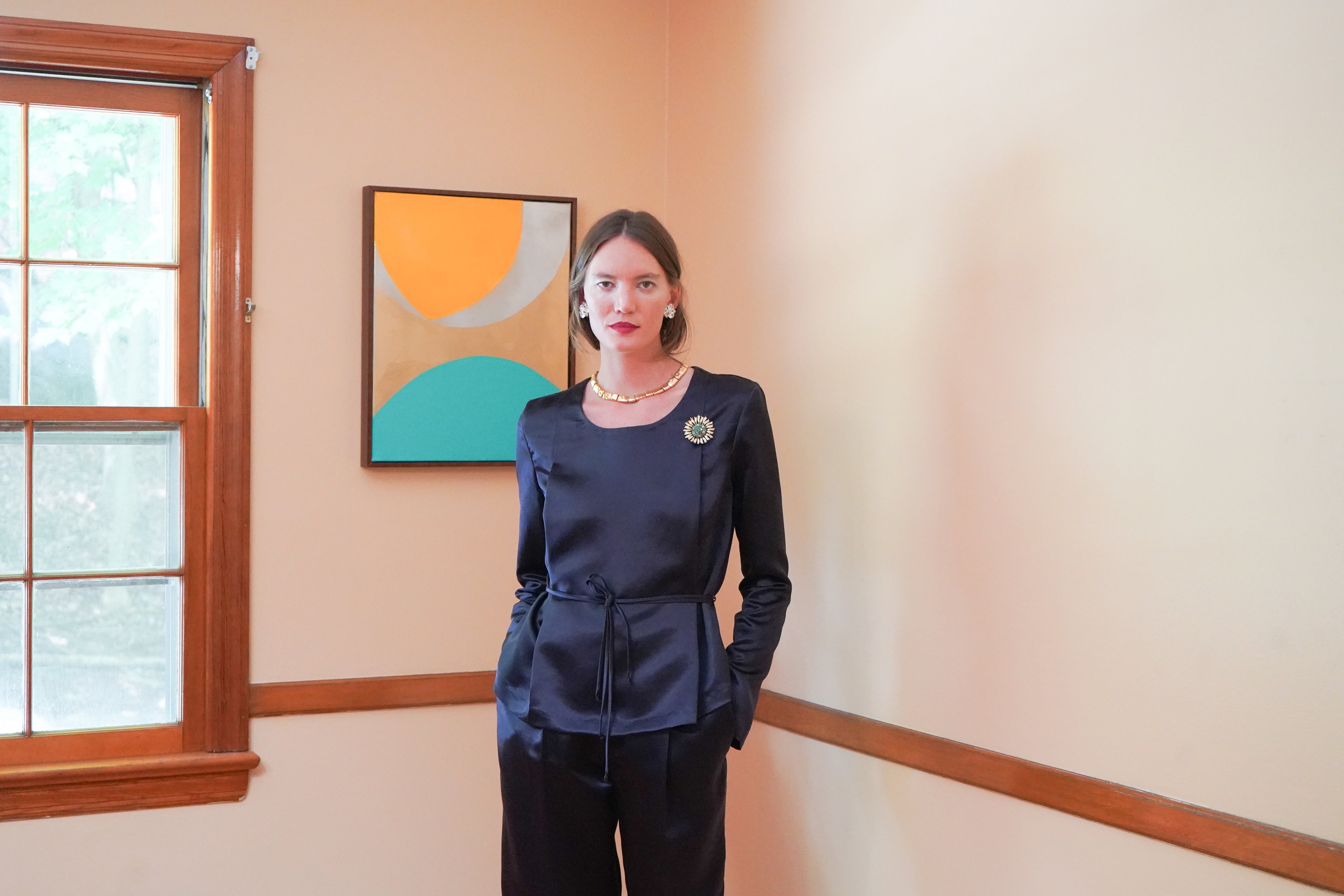 Dark navy satin long-sleeve top with a tie waist and matching dark trousers. 