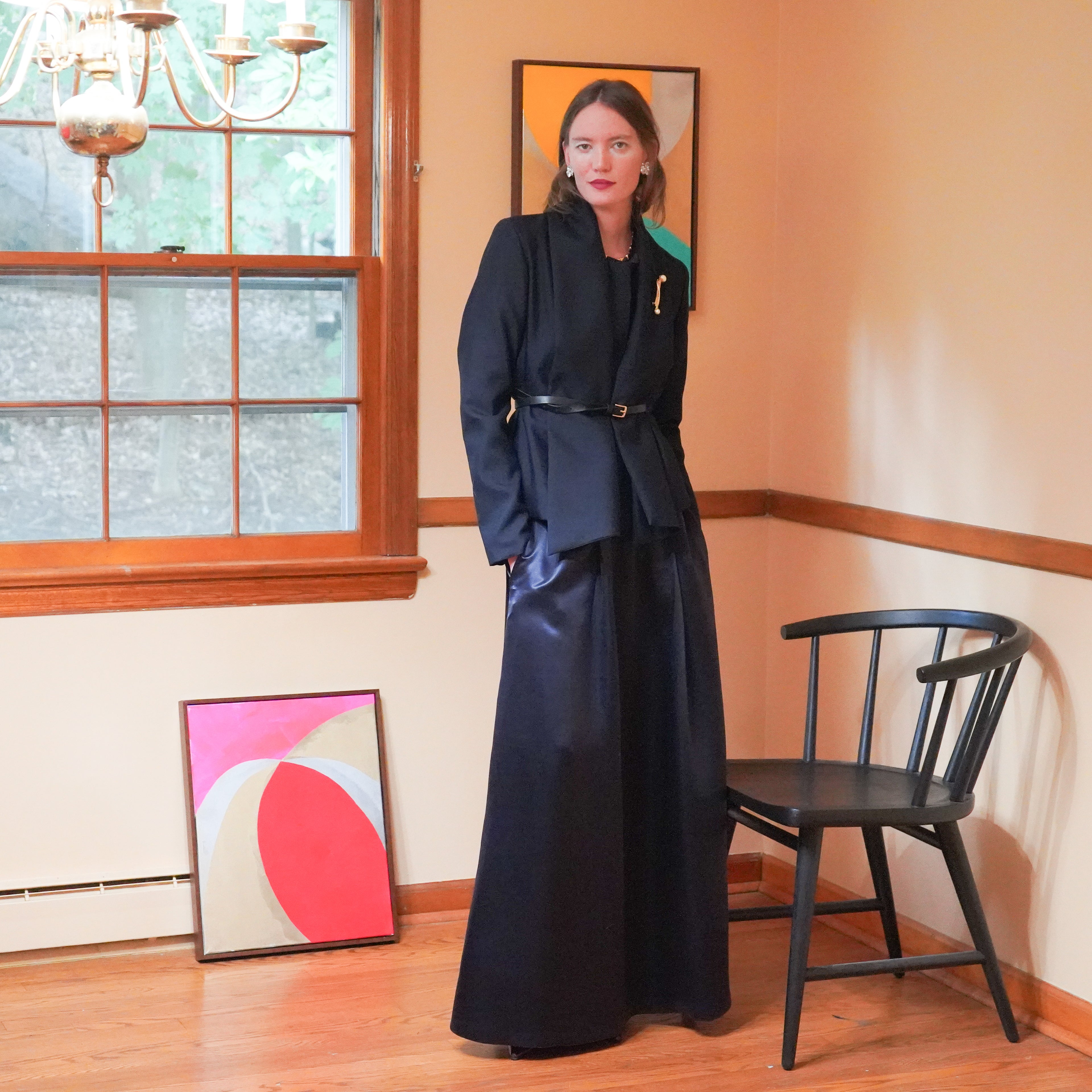 Navy tailored coat with a matching long navy Charmeuse skirt and cinched  black belt. 