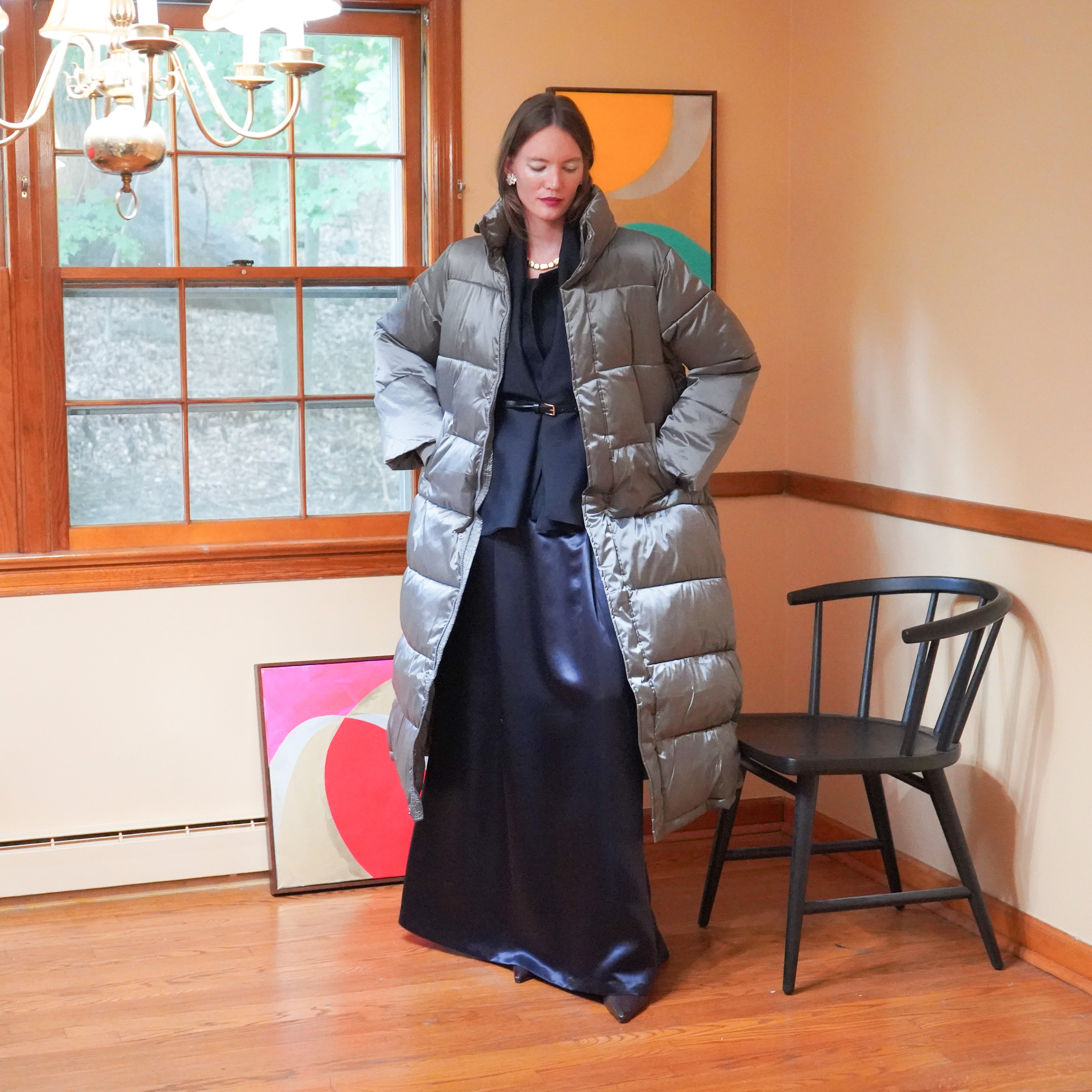 Silver puffer coat over a dark navy charmeuse maxi skirt and dark navy suit